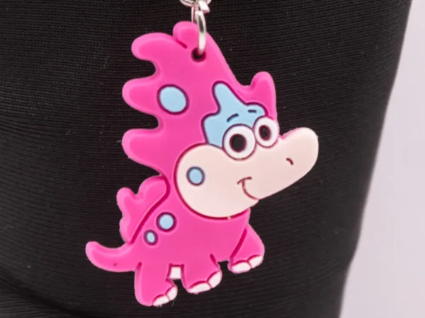Adorable Porte-clés Dinosaure Rose : Un Compagnon Préhistorique et Coloré !