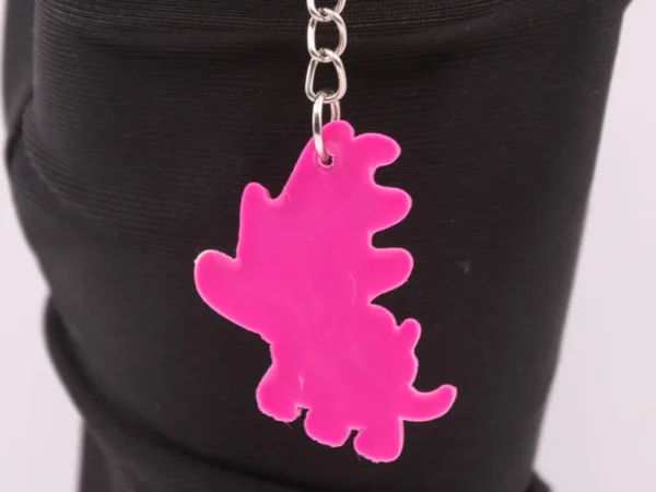Adorable Porte-clés Dinosaure Rose : Un Compagnon Préhistorique et Coloré !
