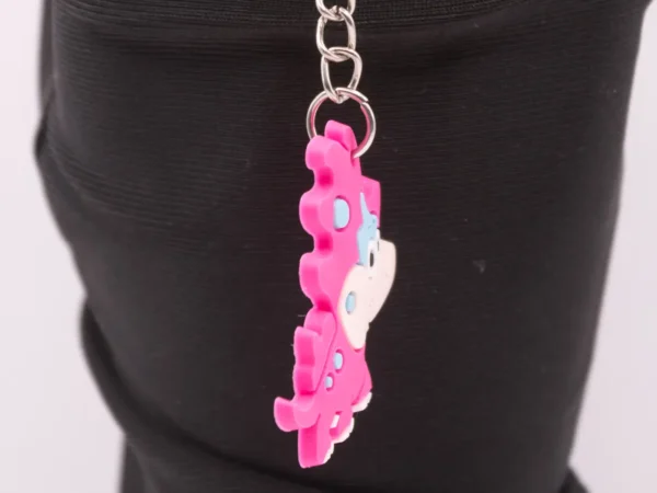 Adorable Porte-clés Dinosaure Rose : Un Compagnon Préhistorique et Coloré !