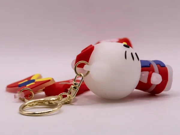 Adorable porte-clés Hello Kitty rouge et violet avec nœud rouge