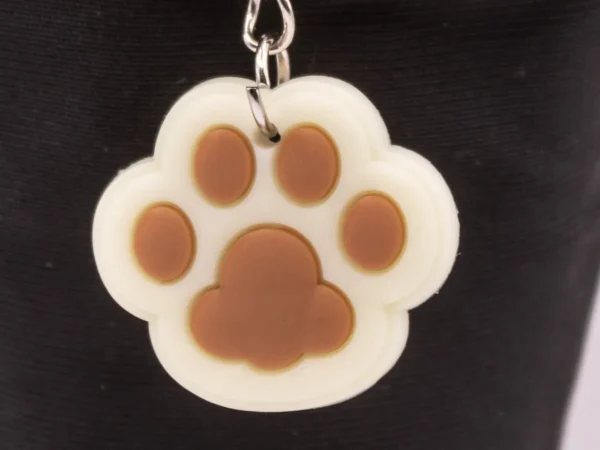 Adorable Porte-clés Patte de Chat en Plastique Beige - Empreinte Féline