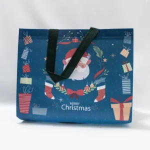 Grand sac cadeau de Noël bleu avec tête de Père Noël en relief